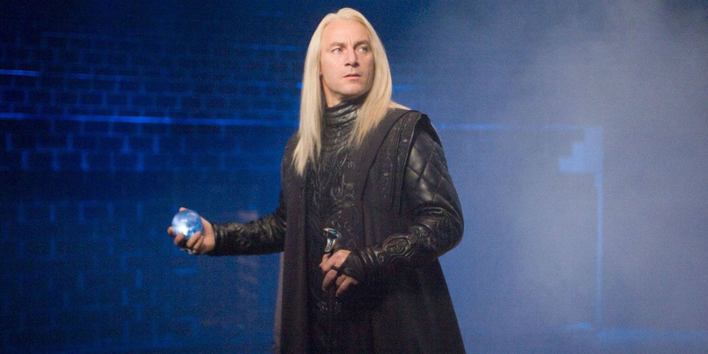 Lucius Malfoy holding a magical artifact