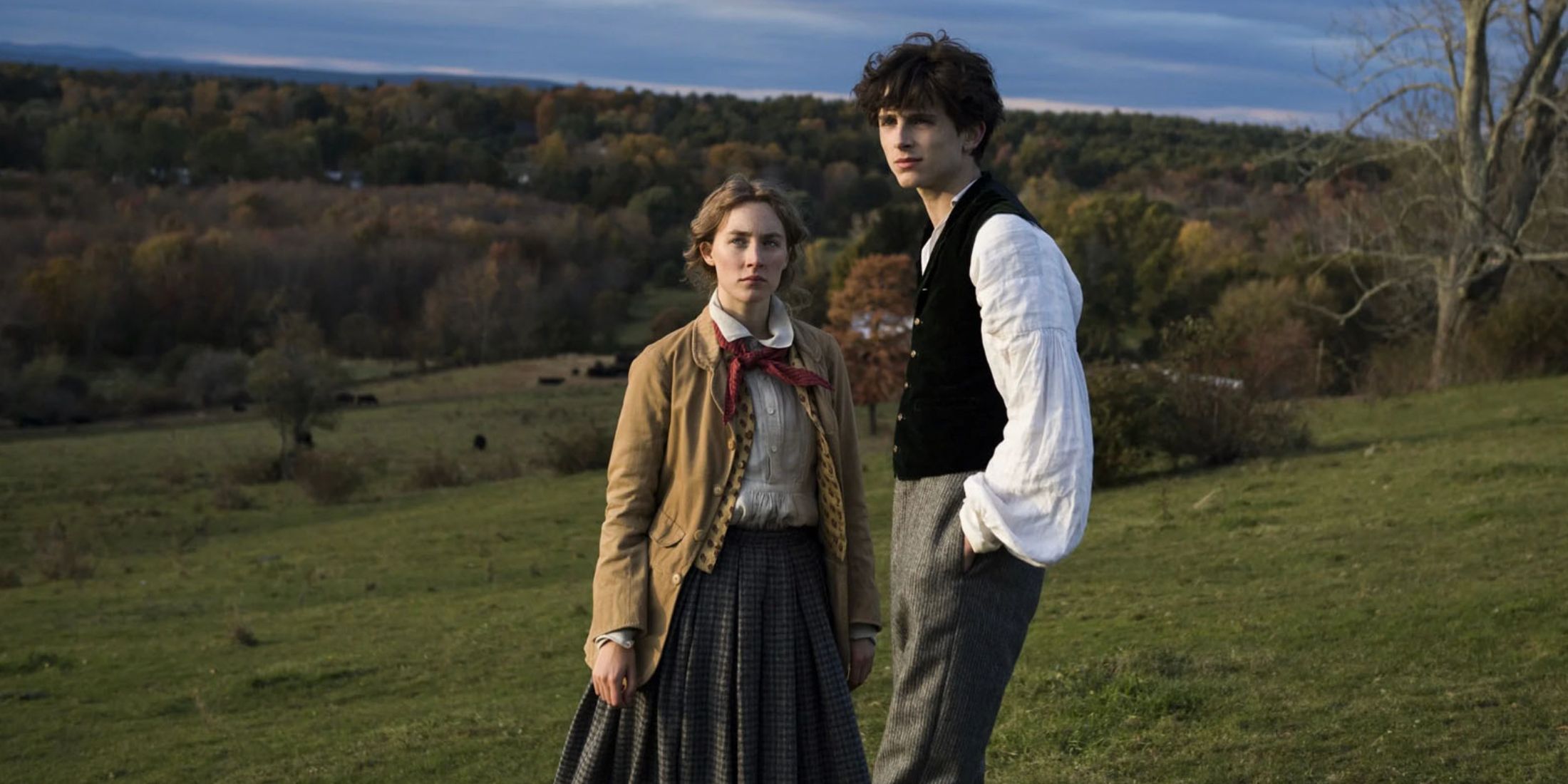 Jo and Laurie stand in a field together in Little Women