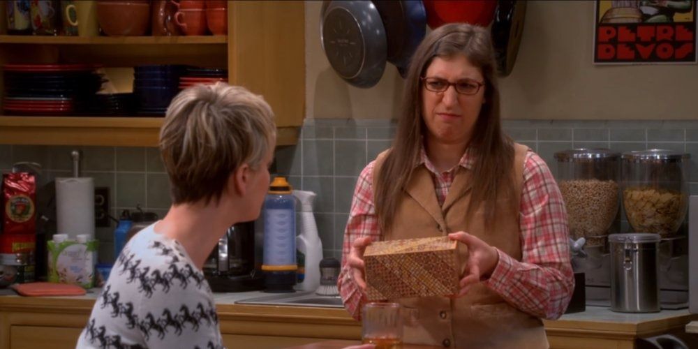 An image of Amy giving Penny the puzzle box in TBBT