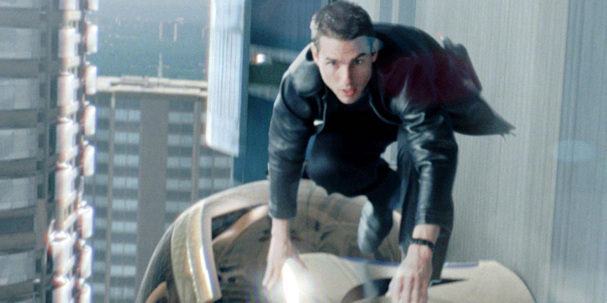 Tom Cruise balancing on top of a moving car pod in Minority Report 2002