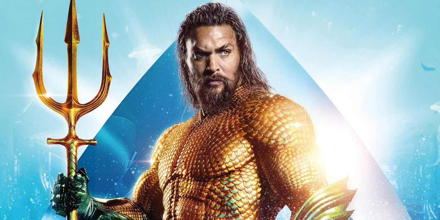 Aquaman standing with his trident in movie