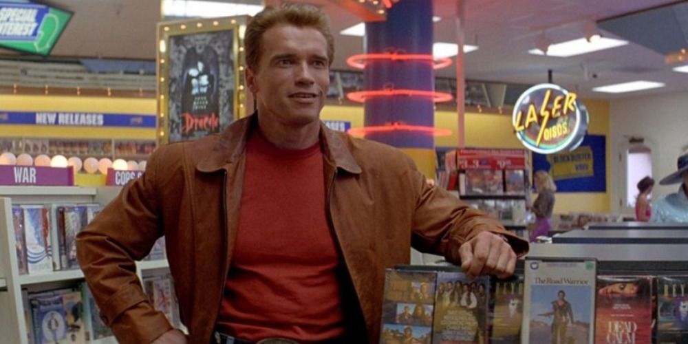 Arnold Schwarzenegger in The Last Action Hero wearing a brown leather jacket in a video store