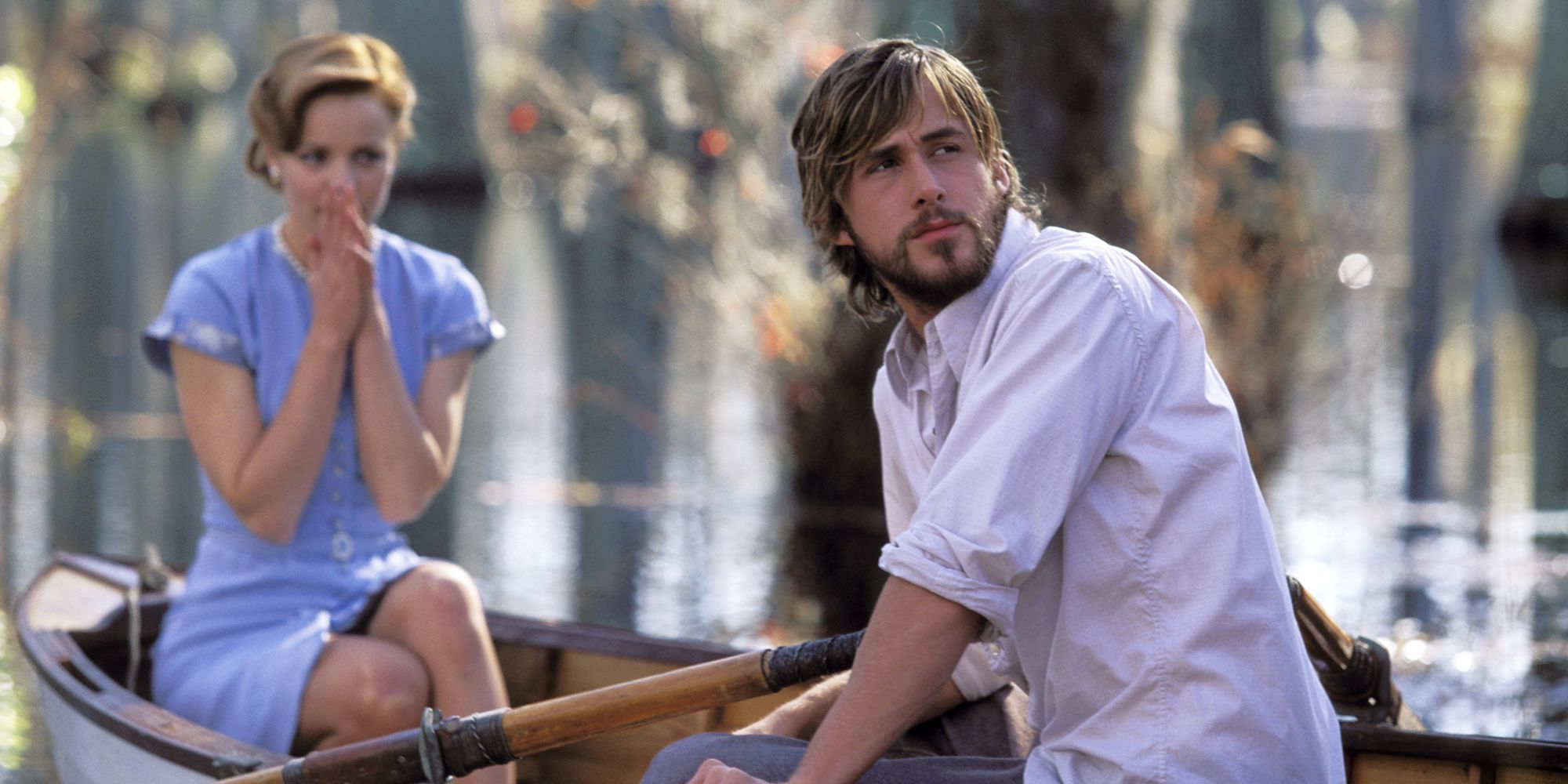Ryan Gosling and Rachel McAdams in The Notebook witting on a boat