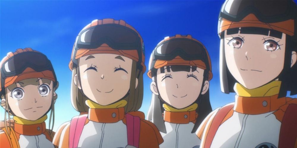 the four main characters of A Place Further Than the Universe smiling at the camera wearing orange protective clothing