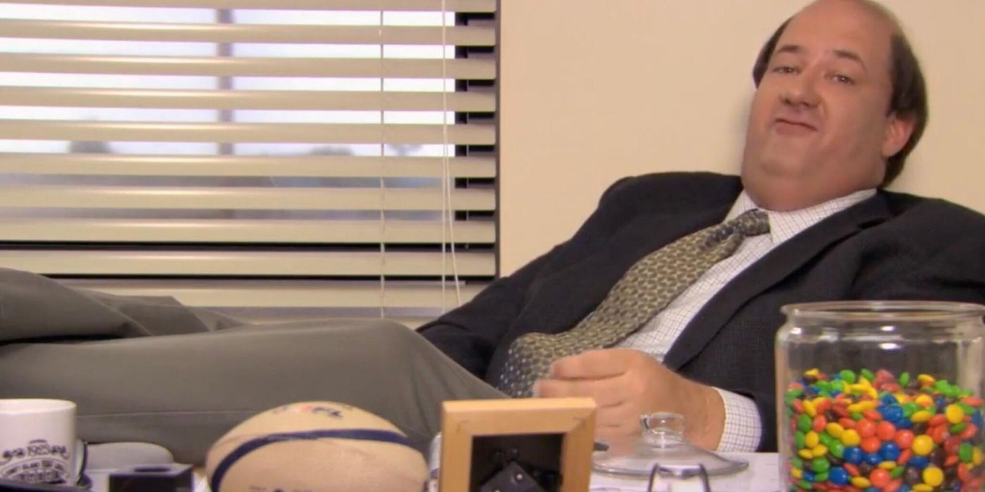 Kevin Malone sitting at Jims desk while looking at the camera on The Office