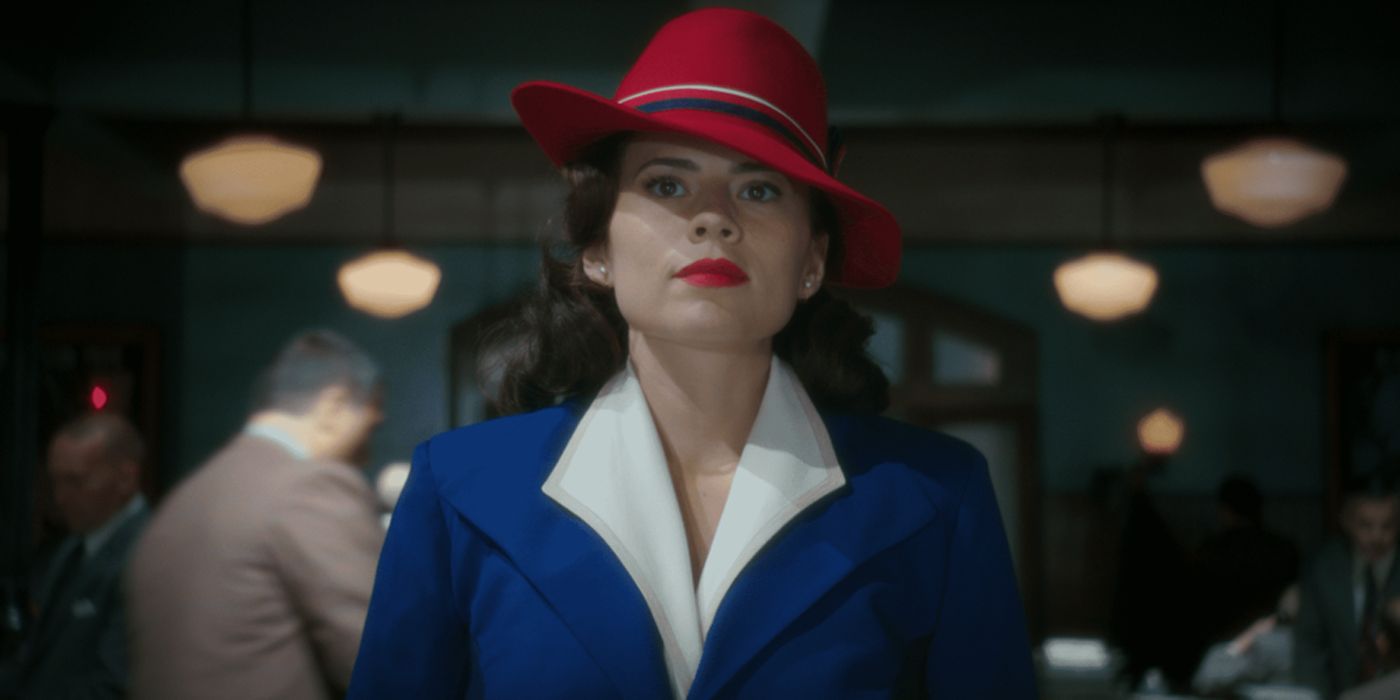 Agent Peggy Carter walking in her office in a red hat