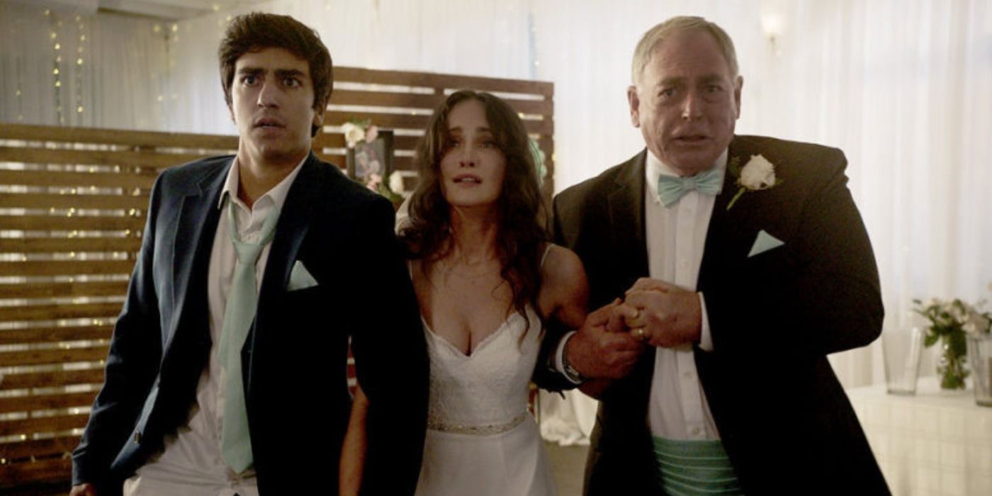 Amy in wedding dress grasps two mens arms in terror in Day of the Dead 1