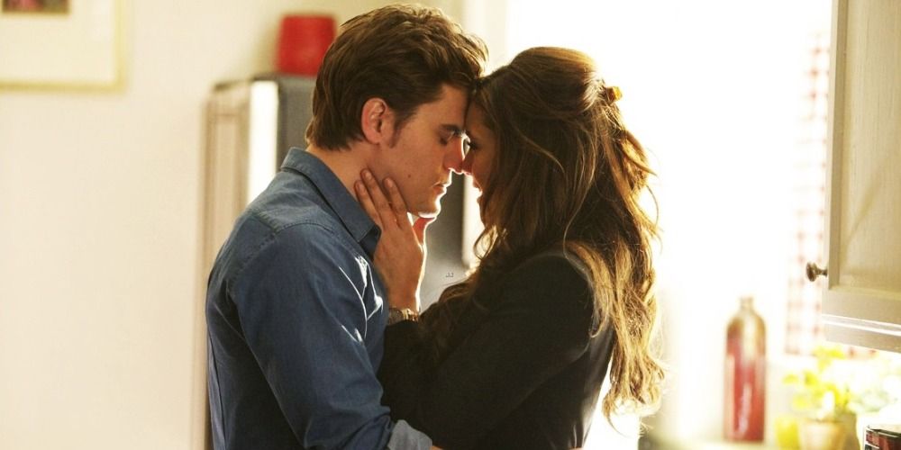 An image of Elena and Stefan hugging in the kitchen in The Vampire Diaries