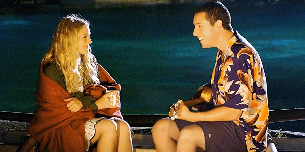 Adam Sandler playing the ukulele and smiling at Drew Barrymore in a still from 50 First Dates Cropped
