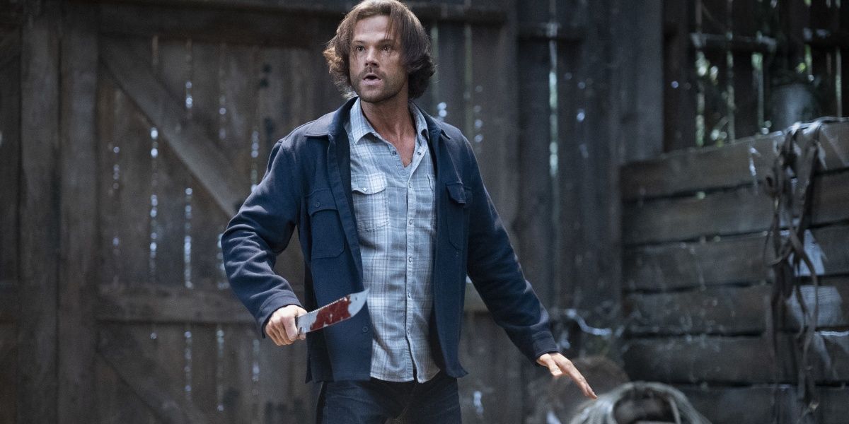 Sam Winchester with a knife in a barn in Supernatural Cropped