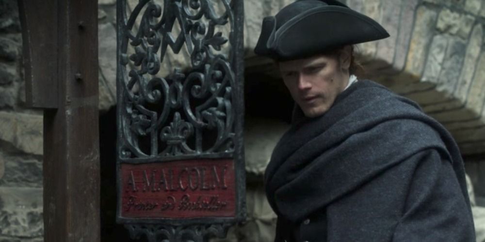 An image of Jamie looking at his printing sign in Outlander