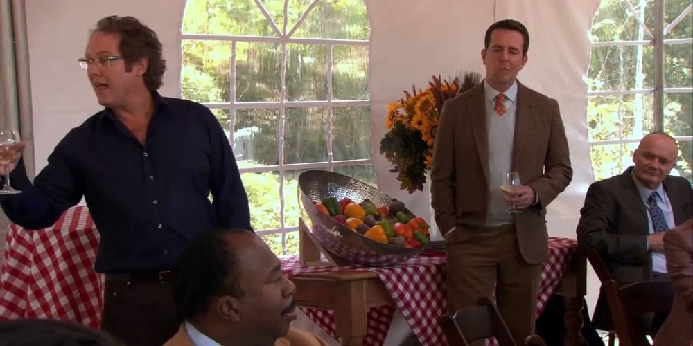 An image of Robert California talking at Andys garden party in The Office