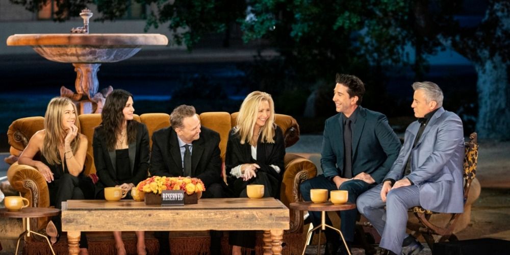 An image of the cast talking on the couch in the Friends reunion