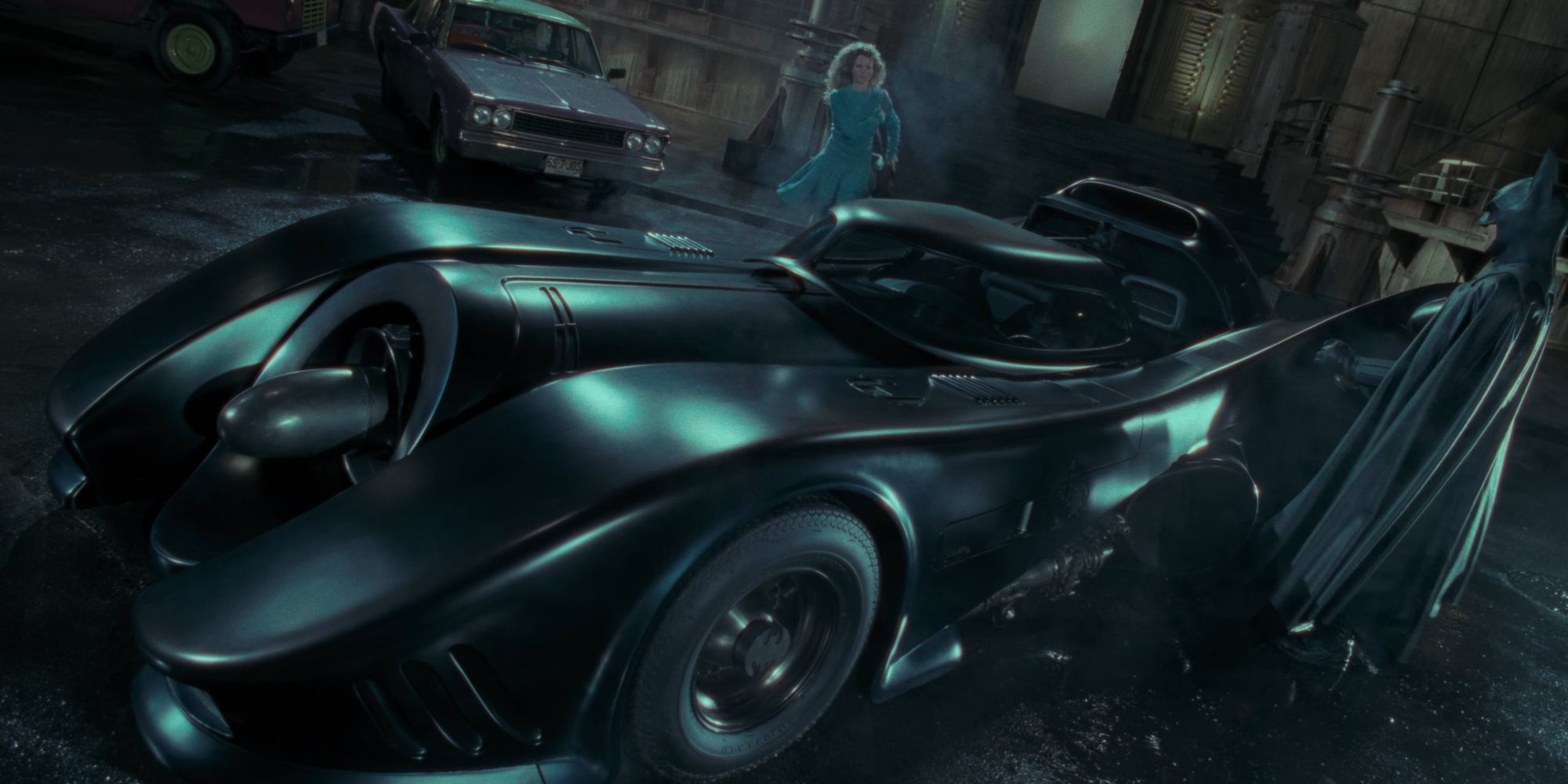 Batman and Vicki Vale approaching the Batmobile in Batman 1989