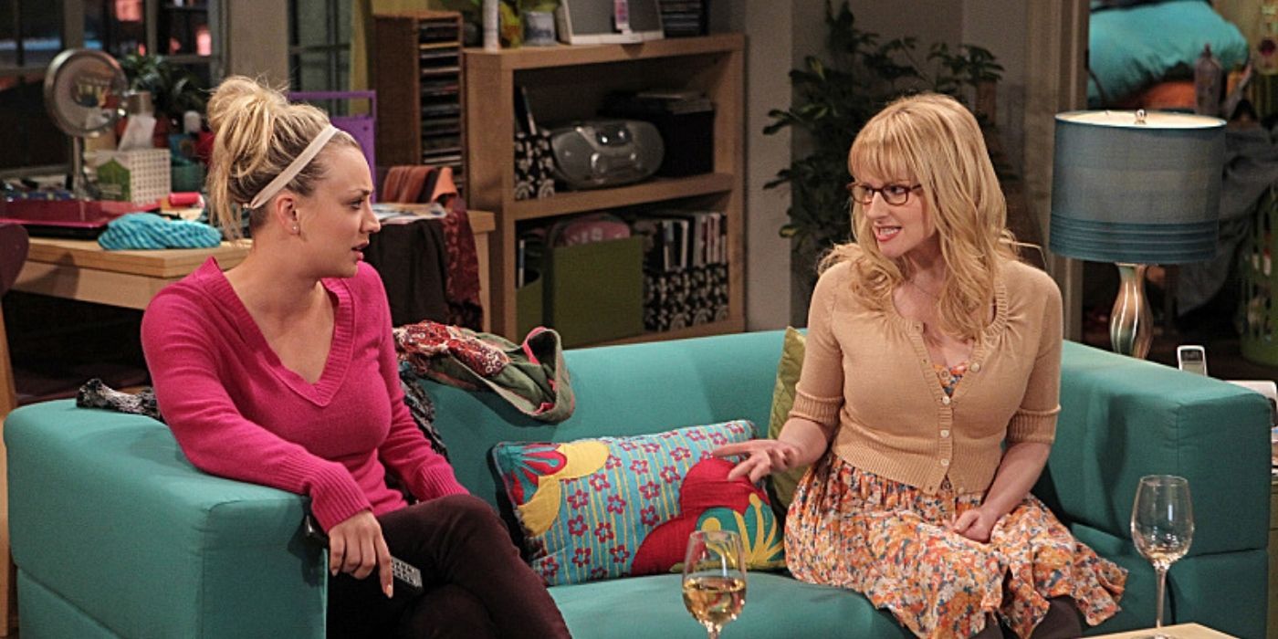Bernadette and Penny talking on the couch with wine on TBBT