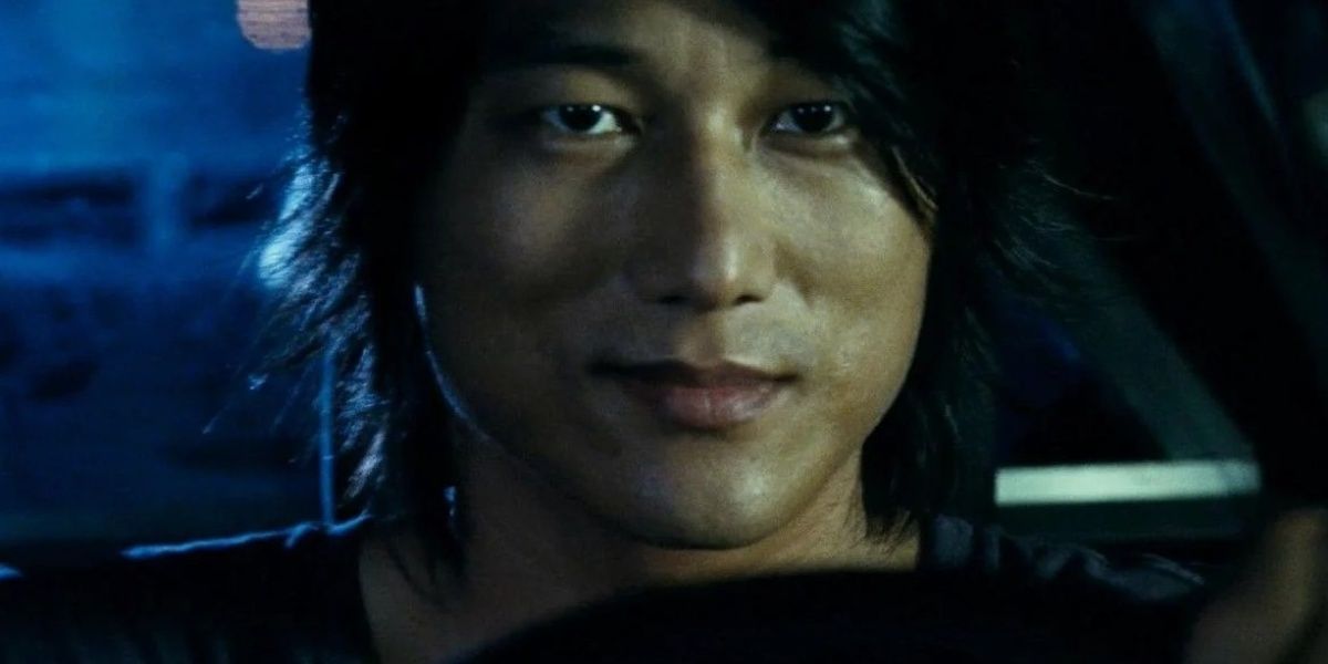 Han Lue smiles while driving in Fast and Furious Cropped Cropped