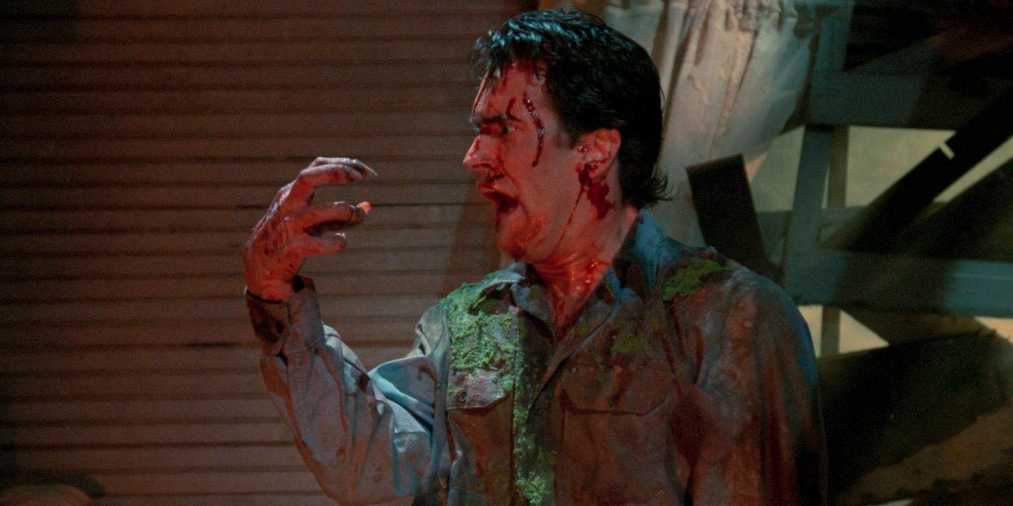 Ash Williams with a possessed hand in Evil Dead II Dead By Dawn