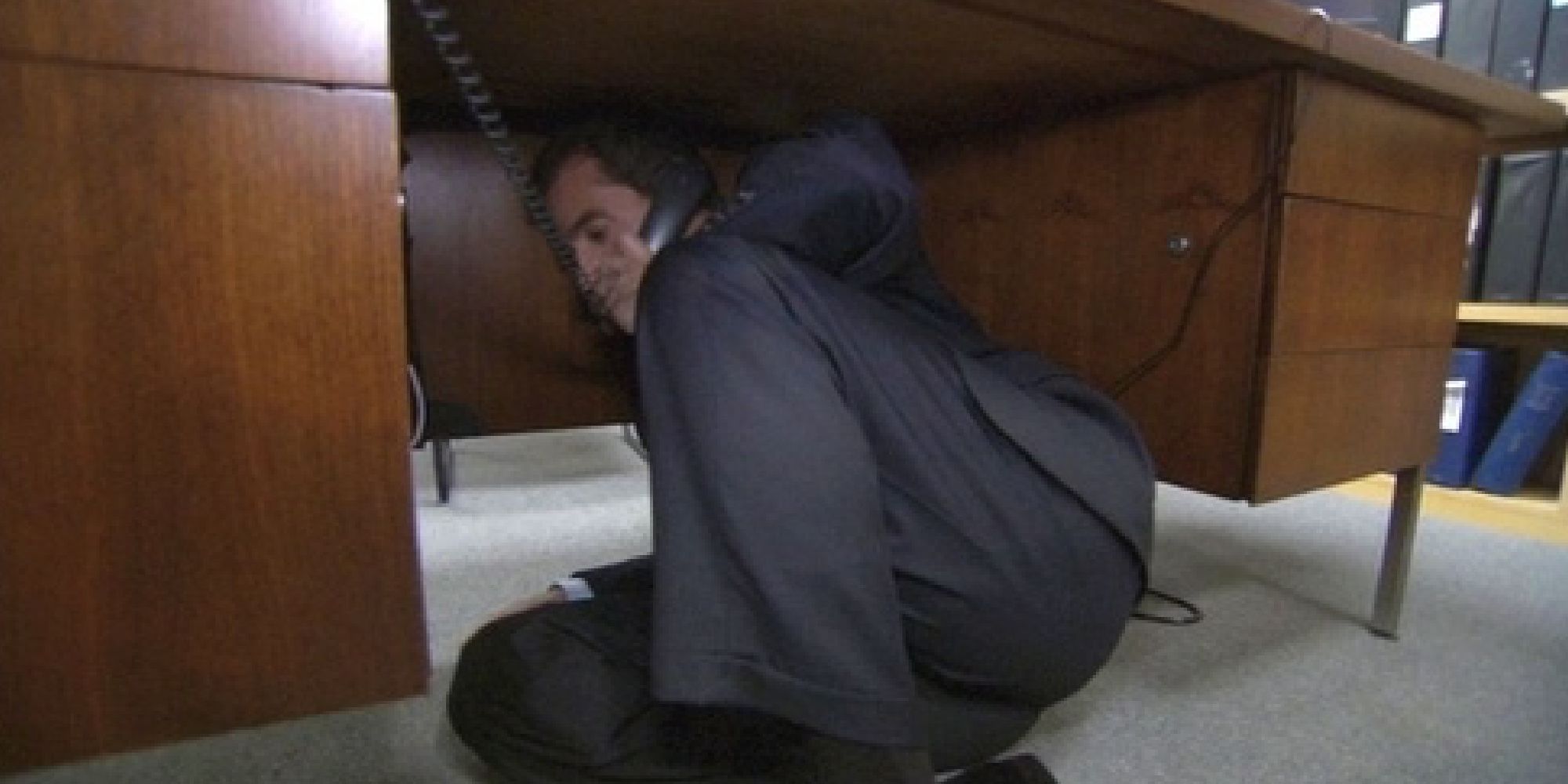 Michael on the phone under his desk on The Office 2