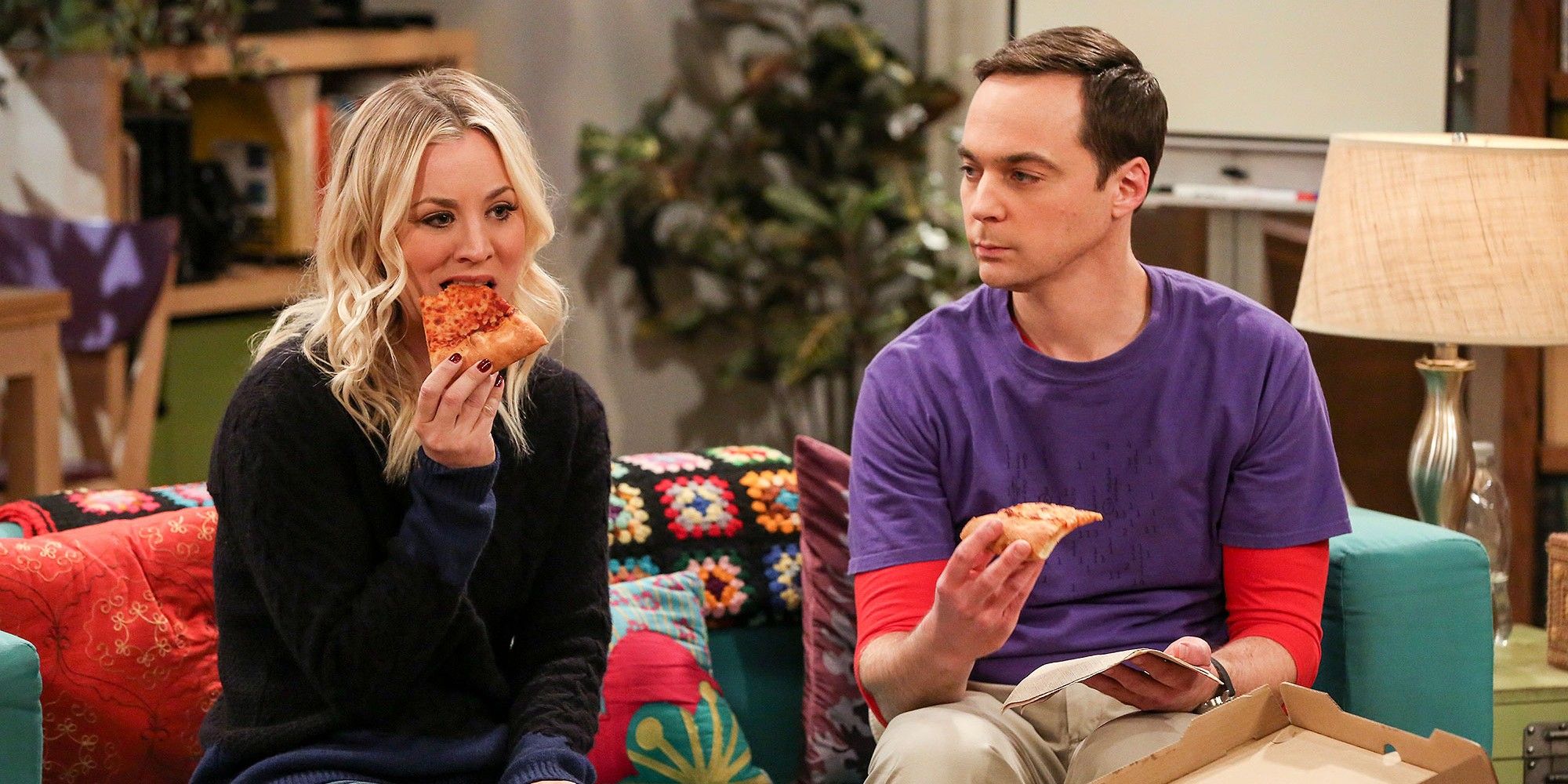 Penny and Sheldon eating pizza on the sofa from TBBT