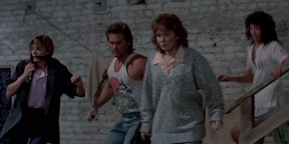 The cast members of Big Trouble in Little China running together Cropped
